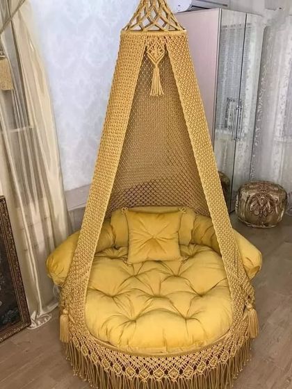 This golden-yellow swing with a matching velvet cushion adds a touch of opulence. It’s perfect for a room with classic and luxurious decor.