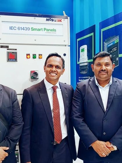 A photo with partners and visitors at my MEE 2025 booth in front of the digitized smart panel display.