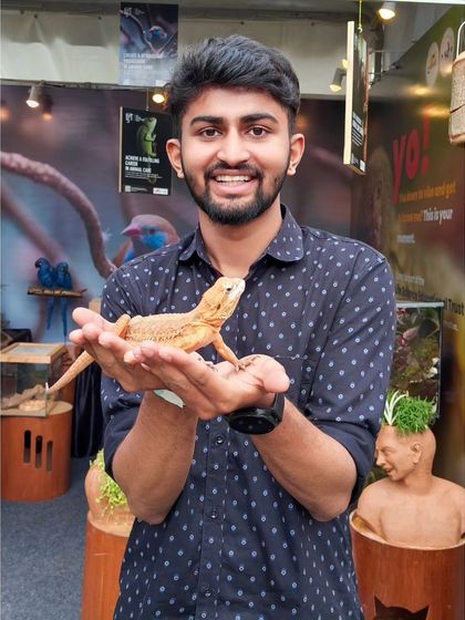 A duplicate of me holding a bearded dragon at Pet Fed. It was fascinating to get up close with these amazing creatures.