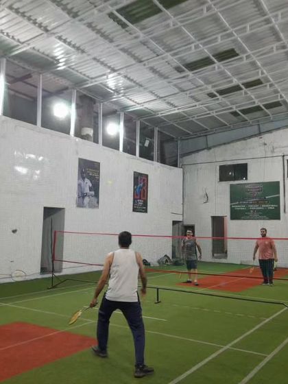 A full court view of a doubles match in progress.