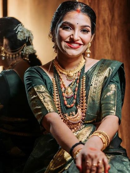 A beautiful close-up portrait of Rashmi. Her smile and the elegant drape of the green silk saree capture the happiness of this special time.