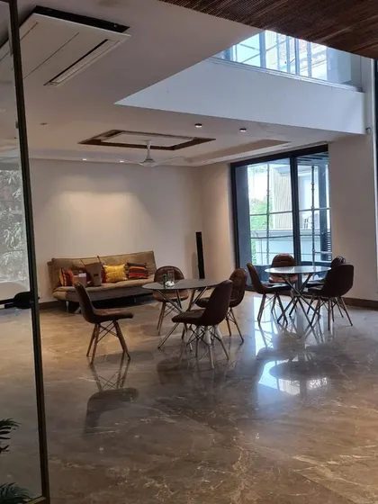 An on-site image of a project in progress, showing the expansive marble floors and large windows. This 'before' shot provides context for the level of transformation our design work entails.