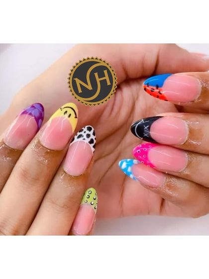 A perfect example of holiday nails where every nail is different. This set features a variety of fun, colorful, and hand-painted designs on classic French tips.