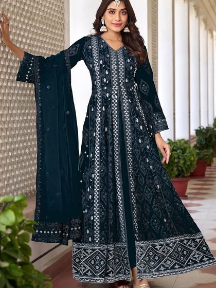 This navy blue Anarkali is all about grandeur. The heavy thread, zari, and sequence embroidery on the velvet fabric make it a truly royal outfit for a winter wedding.