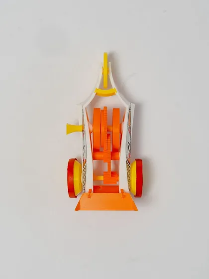A top-down view of the 3D-printed wind-up car, showing the intricate gear system that powers it.