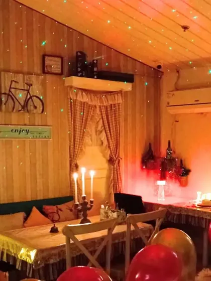 This private dining area is set up with galaxy lighting on the ceiling and warm candlelight to create a dreamy, starry night atmosphere. It's perfect for a birthday or any special occasion.