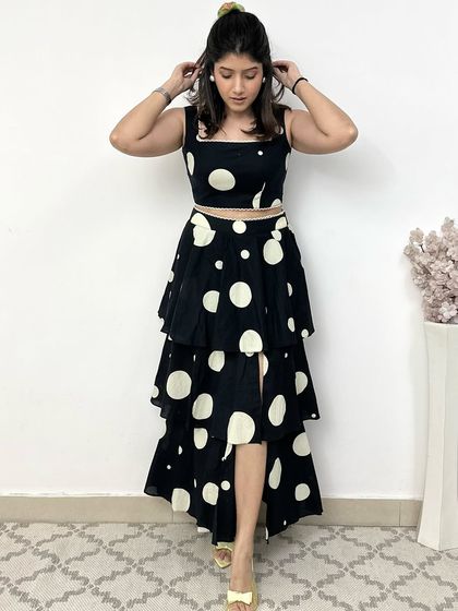 This black and white polka dot co-ord set with a tiered, asymmetrical skirt is all about comfort and fun. It's a statement-making outfit that doesn't compromise on ease of wear.