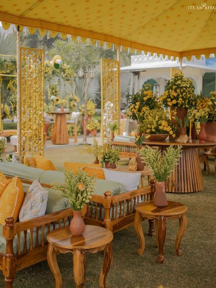 The combination of traditional wooden furniture and modern yellow cushions creates a perfect blend of old and new.