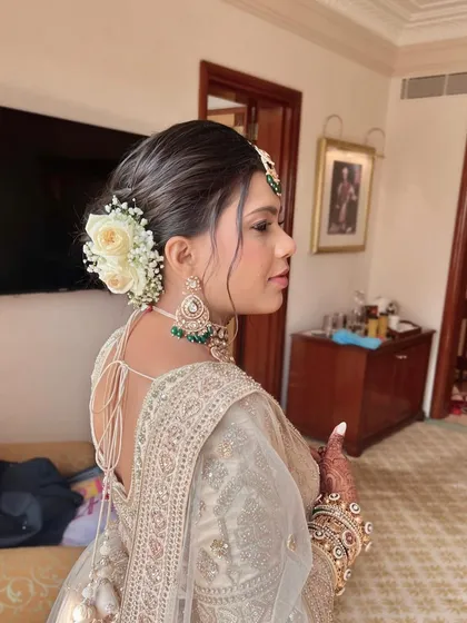 A detailed look at this bride's elegant wedding style, from her flawless makeup to her intricate floral bun.