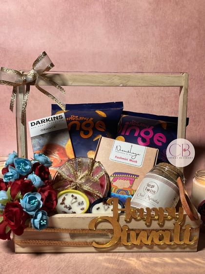 Hampers full of love and light. This Diwali hamper in a pinewood basket is packed with healthy snacks, dhoop cones, and our handmade chocolates and candles.