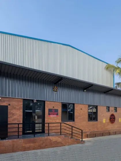 The exterior of the GOAT Club in Bangalore, a sports facility project. This shows how my design principles can be applied to different building types, combining functional needs with materials like exposed brick and steel for a modern, industrial aesthetic.