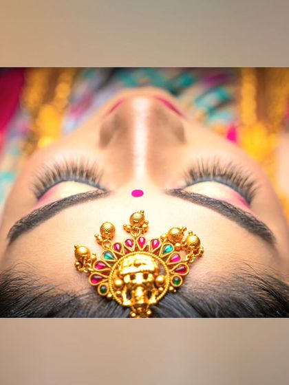 An artistic shot of a bride's maang tikka. This small piece of jewellery makes a big impact on the overall bridal look.
