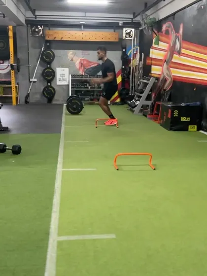 An athlete performs lateral hurdle hops, a drill that enhances side-to-side quickness and footwork.