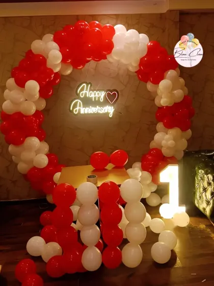 A classic red and white balloon ring for a first anniversary, complete with a neon sign and marquee number.
