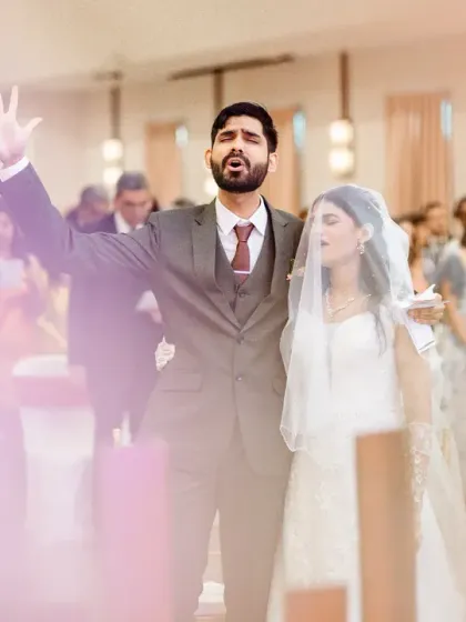 A moment of worship and faith during a church ceremony. The soft, hazy light adds a spiritual and ethereal quality to the photograph.