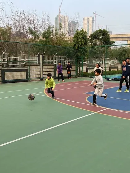 A young player dribbles the ball, focusing on control.