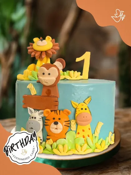 A wild first birthday cake for Reyansh. This jungle-themed creation features a lion, monkey, tiger, zebra, and giraffe, all ready to celebrate the big day.