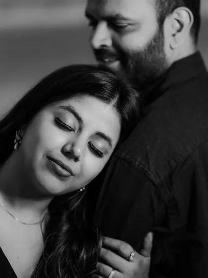 A close, intimate black and white portrait. This pre-wedding shot focuses on the feeling of peace and contentment the couple finds in each other's presence.