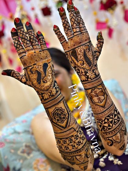 A striking bridal design that combines bold negative space with intricate details. The arms feature a mix of floral patterns, geometric grids, and classic peacock figures, creating a unique and modern bridal look.