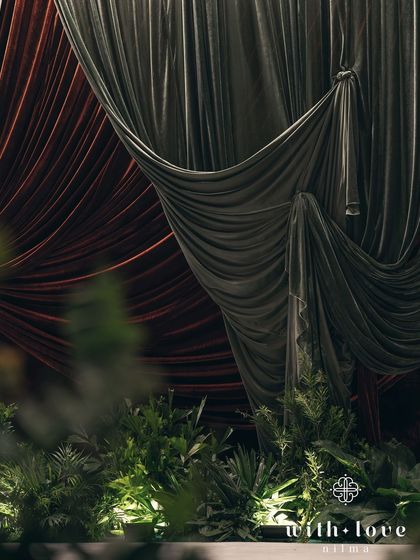 A close-up of the dramatic velvet drapery on the stage. The texture and richness of the fabric play a key role in creating the desired atmosphere.