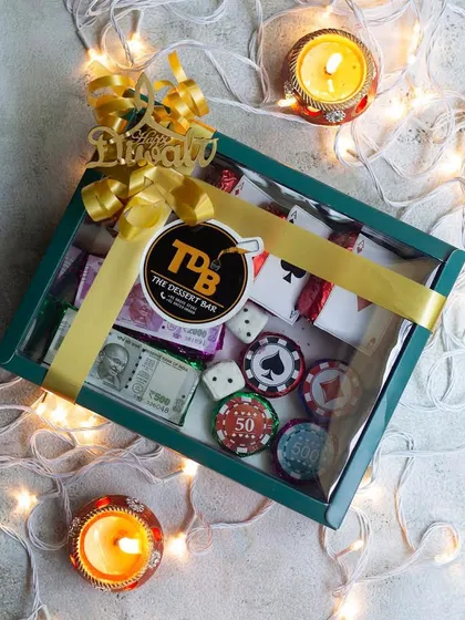 Take your Diwali party to the next level with our edible Poker Set! This creative hamper includes fudgy brownies disguised as playing cards, chocolate-enrobed biscuits as poker chips, and even chocolate dice and currency notes. It's a guaranteed conversation starter.
