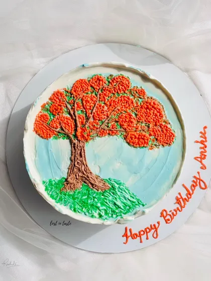 This cake is a tribute to the beautiful Gulmohar tree. The design is hand-piped with colored buttercream to create a miniature painting you can eat.