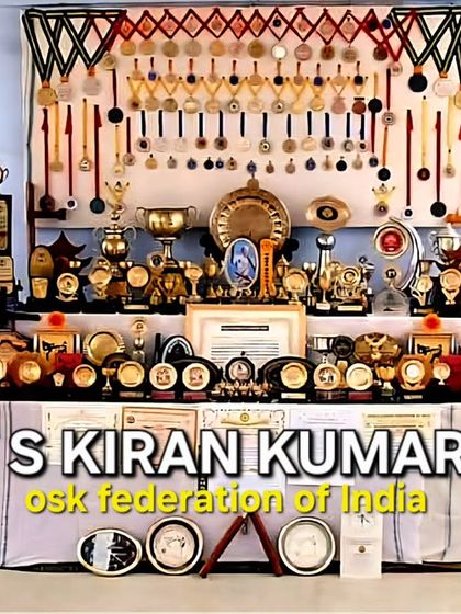 One of our dedicated students, S Kiran Kumari, standing with me in front of a display of her many trophies and medals. Her success is a testament to the results that passion and consistent training can bring.