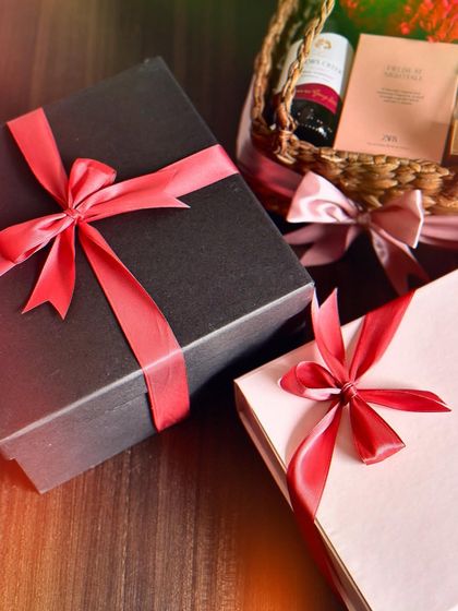 Our Valentine's hampers for him, elegantly wrapped in black and white boxes with red ribbons, ready for gifting.