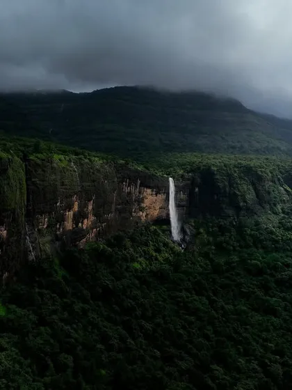 The Daityasur Waterfall near Karjat, seen here under dramatic monsoon clouds. The name itself is formidable, and the waterfall lives up to it, plunging down a sheer cliff face.