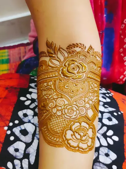 A full arm design showcasing a variety of techniques, including shaded roses, fine lines, and bold patterns.