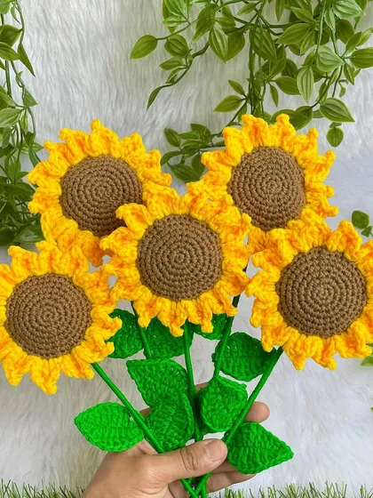 Holding the bunch of five crochet sunflowers. They are so bright and cheerful, and I love making them.