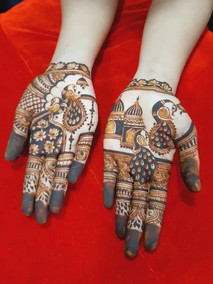 A design for a wedding guest featuring traditional peacock and palace motifs. It's a lighter version of a full bridal design.