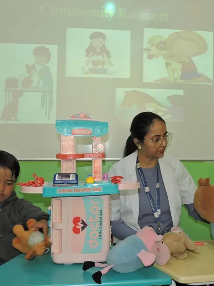 A young student practices being a veterinarian, using a toy stethoscope on a stuffed animal during our 'Animal Care' activity day.