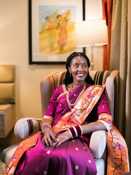A candid portrait of a bride in a gorgeous Paithani saree, her happy expression captured perfectly.