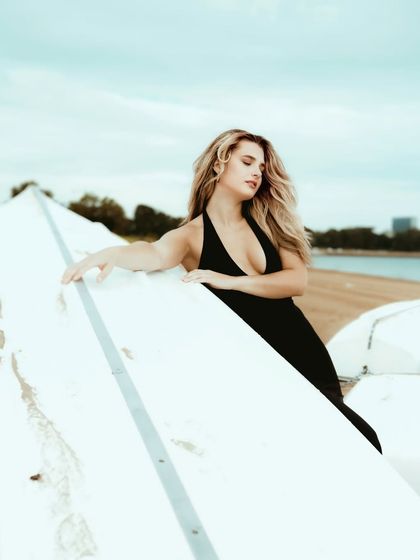 A serene and beautiful portrait, capturing the model in a moment of quiet contemplation on the beach in Goa.