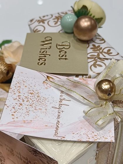 A close-up of the engagement hamper, showing the personalized cards and delicate wrapping. Every detail is meant to convey love and best wishes for the happy couple.