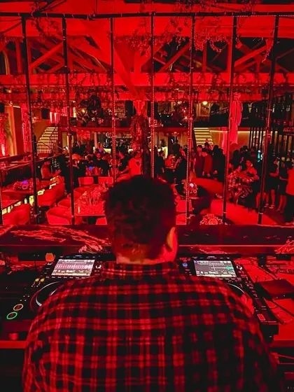 A view from behind the decks during a Halloween party. The red lighting created a spooky, high-energy atmosphere.