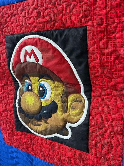 An angled view showing the texture of the quilting on the Mario quilt.