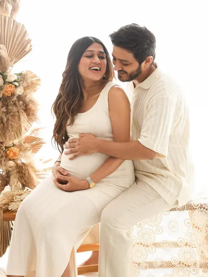 A moment of shared laughter. This candid shot captures the fun and happiness of their journey, surrounded by beautiful dried floral arrangements.