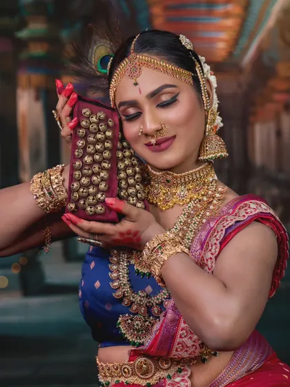 This photoshoot showcases a grand temple jewellery set, perfect for a bride wanting a divine, goddess-like appearance. The set includes multiple necklaces, armlets, and a waist belt.