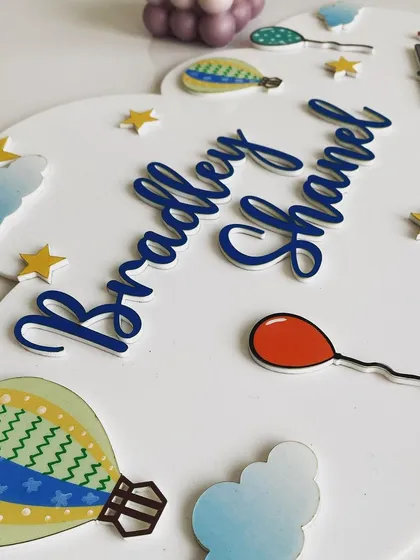 This cloud-shaped name board is all about sweet dreams and sky-high adventures. I designed it with hot air balloons, fluffy clouds, and bright stars to create a whimsical scene that can be personalized with one or two names.