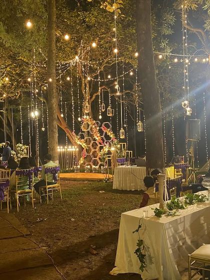 Another perspective of the woodland reception, highlighting the unique honeycomb-like decor piece and the extensive fairy light installation that made the evening so special.