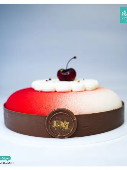 A side view of our Black Forest Revisited cake, highlighting the smooth velvet texture and the clean chocolate band at the base.