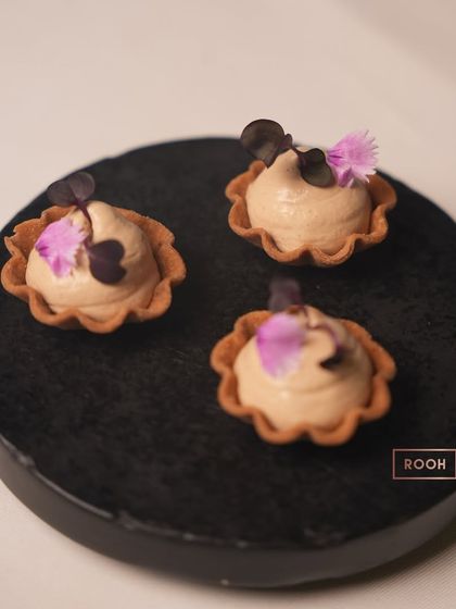 A dessert that evokes childhood memories: our Parle Masala Tea Tarte. A crunchy Parle-G biscuit crust holds a delicate masala chai foam, garnished with edible flowers.