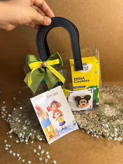 Don't forget your baby brother this Rakhi. This cute hamper includes millet cookies, a fun Mickey Mouse pin, and a special kids' Rakhi card, all packed in a clear mini-tote.