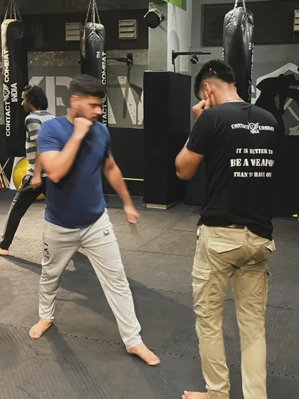Two students spar, practicing their boxing and defensive movements. This kind of live drilling is essential for learning timing, distance, and how to read an opponent.
