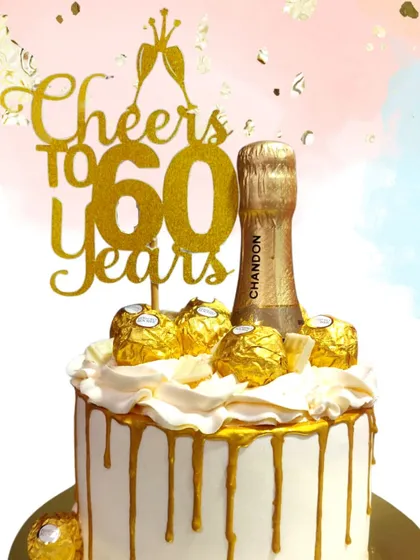 Another "Cheers to 60 Years" creation, this cake is all about golden glamour. The combination of a gold topper, Ferrero Rochers, and a sparkling champagne bottle makes it a standout centerpiece for a milestone party.