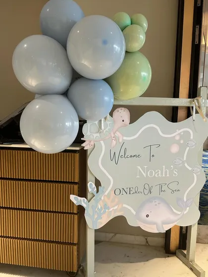 The welcome sign for "Noah's ONEder Of The Sea," featuring adorable illustrated sea creatures and a soft, calming color scheme.