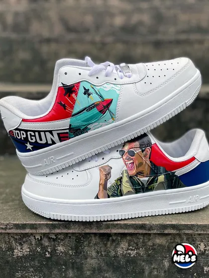 Feel the need for speed with these custom 'Top Gun' themed Nike Air Force 1s. We've got Maverick in his jet on one shoe and a portrait of Tom Cruise on the other, complete with the iconic movie logo. It's the ultimate wearable tribute for any fan of the film.