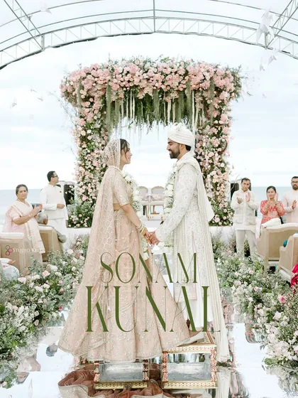 Against the serene backdrop of the Thailand coast, the couple shares a quiet moment under a magnificent floral mandap. This image captures the peaceful, romantic essence of a destination beach wedding.